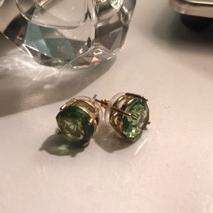 Large diamond earrings with green gem